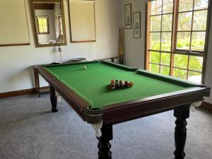 a green pool table with balls on top of it at David's at Hillcrest in Anglesea