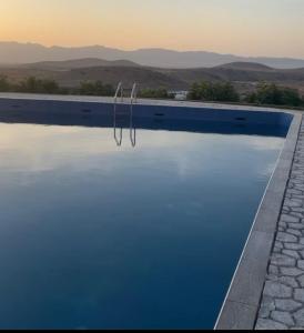 a swimming pool with a reflection in the water at Maison d'Hôte - Le Beau Panorama in Berkane +15 photos