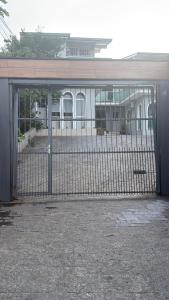 an open gate in front of a building at Private Suite Confortable Stay in Florianópolis