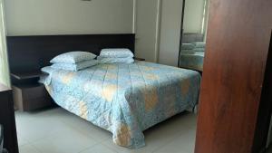 a bedroom with a bed with two pillows on it at Private Suite Confortable Stay in Florianópolis