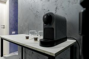 a computer monitor sitting on a table with wine glasses at SECRET JACUZZl & LOVE in Bucharest