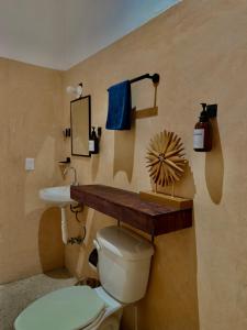 a bathroom with a toilet and a sink at Suku'un in Brisas de Zicatela +134 photos