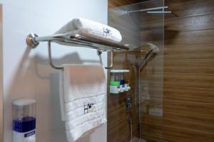 a towel rack in a bathroom with a shower at Huallata Hotel Boutique in Huaraz +54 photos