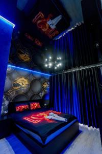 a room with a bed with signs on the wall at SECRET JACUZZl & LOVE in Bucharest