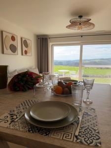 a dining room table with a plate of fruit on it at Lavand'in Durbuy in Durbuy
