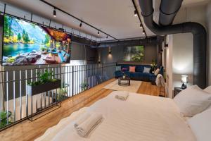 a bedroom with a large tv on the wall at R2 apartman in Kecskemét