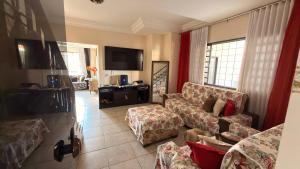 a living room with a couch and a table at Sobrado de lazer rita in Aparecida de Goiânia