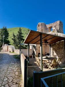 a patio with a table and chairs under a pavilion at La Gemma del Subasio nel Castello di Collepino - Spello in Collepino