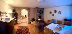 a living room with a table and chairs and a fireplace at La Gemma del Subasio nel Castello di Collepino - Spello in Collepino