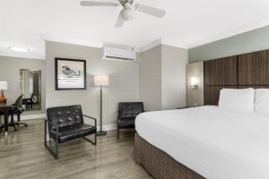 a hotel room with a bed and a desk and chairs at Best Western Historic Bayfront in St. Augustine +28 photos