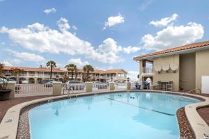 a large swimming pool at a resort with a building at Best Western Historic Bayfront in St. Augustine