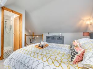 a bedroom with a large bed and a bathroom at The Retreat - Uk45099 in Kirklington