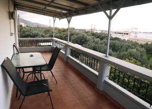 a balcony with a table and chairs and a view at AnastasiaSunsetView in Souda