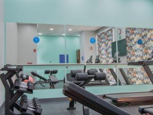 a gym with several treadmills and a mirror at Tru By Hilton Puebla Angelopolis in Puebla