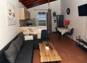 a living room with a couch and a table at AnastasiaSunsetView in Souda