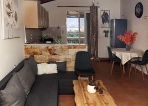 a living room with a couch and a table at AnastasiaSunsetView in Souda