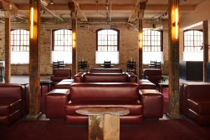 a waiting room with leather couches and a table at Pocketbook Hotel and Baths in Hudson