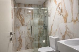 a bathroom with a shower and a toilet and a sink at Ermida Vista Douro in Baião
