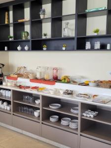 a kitchen with white plates and dishes on shelves at Refugio del Turista in Tupiza