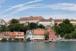 a group of buildings next to a body of water at RELAX - APPARTEMENTS Allgäu I Berge I Familien I Paare I Business I Wellness I WLAN I Parkplatz in Scheidegg