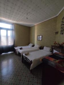 a hotel room with two beds and a window at Appartement 3 pièces in LʼAgha