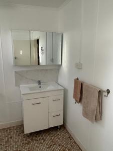 a bathroom with a sink and a mirror and towels at KI Caravan Park, Kingscote in Kingscote +80 photos