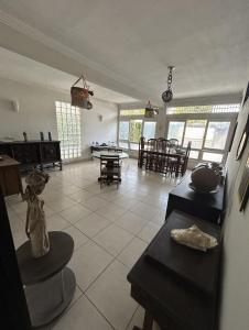 a kitchen and living room with tables and chairs at Pousada Rio Doce in Olinda
