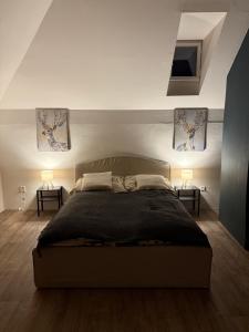 a bedroom with a large bed and two lamps at Apartmán 19 in Mikulov +2 photos