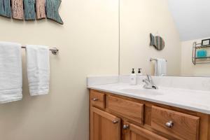 a bathroom with a sink and a mirror and towels at Bay Park 32: Downtown Condo! in Traverse City +44 photos
