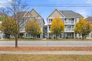 a row of houses on a street with trees at Bay Park 32: Downtown Condo! in Traverse City