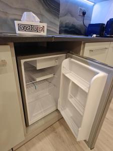 an empty refrigerator with its door open on a counter at Clonakilty Cozy Nest in Clonakilty