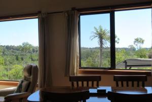 a room with a table and chairs and a large window at Beaconstone - your perfect escape in Charleston