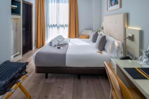 a hotel room with a large bed and a desk at Hotel SERHS Del Port in Barcelona +54 photos