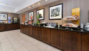 a restaurant with a buffet line with food at Hampton Inn Chicago-Carol Stream in Carol Stream
