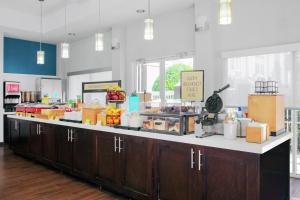 a cafeteria with a counter with food on it at Hampton Inn Lake Buena Vista / Orlando in Orlando