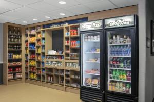 a grocery store aisle with shelves of food and drinks at Hampton Inn Lake Buena Vista / Orlando in Orlando