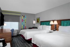 a hotel room with two beds and a flat screen tv at Hampton Inn Lake Buena Vista / Orlando in Orlando +16 photos
