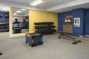 a gym with dumbbells and a mirror in a room at Hampton Inn - York in York