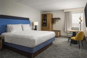 a hotel room with a bed and a desk at Hampton Inn - York in York +27 photos