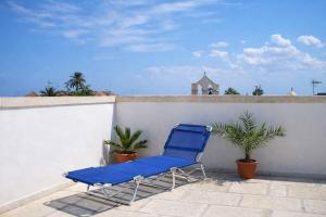 a blue chair sitting on top of a wall at Palazzo Luceri in Galatina