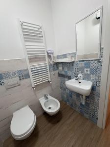 a bathroom with a toilet and a sink at Solaria House in Montesilvano +7 photos