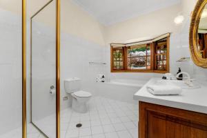 a bathroom with a shower and a toilet and a sink at Tiverton in Kurrajong +21 photos