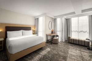 a hotel room with a bed and a desk at Embassy Suites by Hilton Cincinnati Northeast - Blue Ash in Blue Ash +49 photos