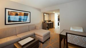 a living room with a couch and a table at Embassy Suites by Hilton Cincinnati Northeast - Blue Ash in Blue Ash