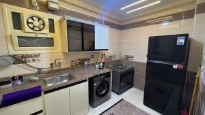 a small kitchen with a sink and a dishwasher at دمياط الجديدة جنة مصر in Dumyāţ al Jadīdah