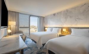 a hotel room with two beds and a window at Hilton Dublin in Dublin +73 photos