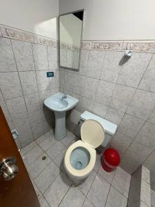 a bathroom with a toilet and a sink at Hospedaje W TAWA in Lima