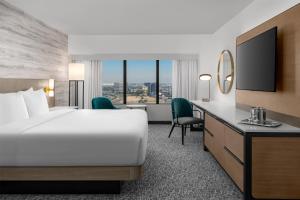 a hotel room with a bed and a desk at Hilton Los Angeles Airport in Los Angeles +86 photos