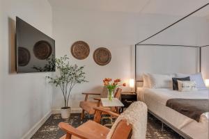 a bedroom with a bed and a chair and a table at The Orenco Station Hotel in Hillsboro +12 photos