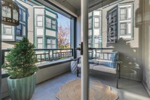 a porch with a potted tree and a window at The Orenco Station Hotel in Hillsboro